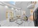 Bright living room boasts marble floors, high ceilings, and ample natural light from large windows and an open design at 15702 Richboro Ct, Tampa, FL 33647