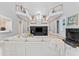 Expansive living room showcases high ceilings, marble floors, and a central entertainment center with dual upper-level balconies at 15702 Richboro Ct, Tampa, FL 33647