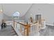 Open second floor loft with high ceilings, a statement window, and wood railing at 15702 Richboro Ct, Tampa, FL 33647