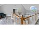 Second story landing featuring vaulted ceilings, wood and white railing and lots of natural light at 15702 Richboro Ct, Tampa, FL 33647