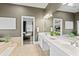 Large main bathroom featuring double sinks, marble counters, and a serene aesthetic at 15702 Richboro Ct, Tampa, FL 33647