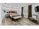 Spacious main bedroom featuring modern decor, an accent wall, and stylish curtains at 15702 Richboro Ct, Tampa, FL 33647