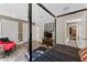 Comfortable main bedroom with walk-in closets, TV, and view to hall at 15702 Richboro Ct, Tampa, FL 33647