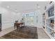 Bright office features a large desk, built-in bookshelves, and French doors to let in light and enhance productivity at 15702 Richboro Ct, Tampa, FL 33647