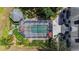 Aerial view of a screened pool and patio area, surrounded by well-maintained landscaping and connecting walkways at 15702 Richboro Ct, Tampa, FL 33647