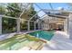 Beautiful screened-in pool with attached spa and patio furniture provides a relaxing outdoor oasis at 15702 Richboro Ct, Tampa, FL 33647