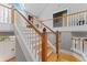 Elegant wooden staircase with white spindles leading to the upper level of the home at 15702 Richboro Ct, Tampa, FL 33647