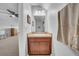 Small bathroom offering a compact vanity with a white sink, a mirror, neutral paint, and cabinet storage at 15861 Starling Water Dr, Lithia, FL 33547
