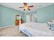 The bedroom features a light turquoise color, light carpet, and a ceiling fan at 15861 Starling Water Dr, Lithia, FL 33547