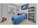 Bedroom with neutral walls, one window, a bookcase, a desk and a rocking horse for decor at 15861 Starling Water Dr, Lithia, FL 33547