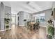 Open concept dining room with wood floors, a large window and views of the entry at 15861 Starling Water Dr, Lithia, FL 33547