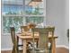 Dining room with a wooden table, decorated with greenery, and a large window at 15861 Starling Water Dr, Lithia, FL 33547