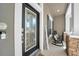 Welcoming front porch with rocking chairs, a decorative door, and stylish stone accents at 15861 Starling Water Dr, Lithia, FL 33547