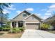 Inviting single-story home with a well-kept lawn, two-car garage, and a covered front porch area at 15861 Starling Water Dr, Lithia, FL 33547