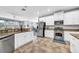 Modern kitchen featuring stainless steel appliances, granite countertops, and white cabinetry at 15861 Starling Water Dr, Lithia, FL 33547