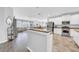 Bright kitchen area with hardwood floors, white cabinets, granite countertops and stainless steel appliances at 15861 Starling Water Dr, Lithia, FL 33547