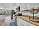 Open concept kitchen with white cabinets, stainless steel appliances, and a view into the living area at 15861 Starling Water Dr, Lithia, FL 33547
