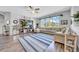 Inviting living room featuring a comfortable sectional, hardwood floors, and a large entertainment center at 15861 Starling Water Dr, Lithia, FL 33547