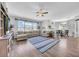 Bright and airy living room featuring hardwood floors, a cozy sofa, and large windows at 15861 Starling Water Dr, Lithia, FL 33547