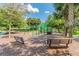 Outdoor playground equipment on mulch bed with green play structures, swings, climbing features and benches surrounded by green trees at 15861 Starling Water Dr, Lithia, FL 33547