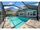 Covered pool area with screened enclosure and brick patio, perfect for year-round enjoyment at 15861 Starling Water Dr, Lithia, FL 33547