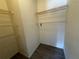 This walk-in closet has ample storage with metal shelving and wood-look flooring at 1830 Bough Ave # 4, Clearwater, FL 33760