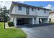 Two-story condo building featuring covered parking and a balcony on the second floor at 1830 Bough Ave # 4, Clearwater, FL 33760