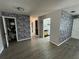 Open-concept living area showcasing the luxury vinyl plank flooring and faux stone accent wall at 1830 Bough Ave # 4, Clearwater, FL 33760