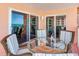 Cozy balcony featuring a round table and comfortable seating, perfect for enjoying a glass of wine and ocean views at 18400 Gulf Blvd # 1211, Indian Shores, FL 33785