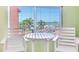 Bright view of the beach from an indoor balcony, complete with table and chairs for relaxing and enjoying the scenery at 18400 Gulf Blvd # 1211, Indian Shores, FL 33785