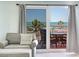View from sitting area through glass doors to a beachfront balcony at 18400 Gulf Blvd # 1211, Indian Shores, FL 33785