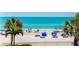 Beautiful beach view with white sand, palm trees, and blue water at 18400 Gulf Blvd # 1211, Indian Shores, FL 33785