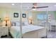 Charming bedroom with a stylish four-poster bed, scenic views, and elegant furnishings at 18400 Gulf Blvd # 1211, Indian Shores, FL 33785