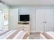 Bedroom provides a functional space with TV, storage, and easy access to other areas at 18400 Gulf Blvd # 1211, Indian Shores, FL 33785