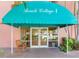 Entrance to Beach Cottage I with teal awning and glass doors at 18400 Gulf Blvd # 1211, Indian Shores, FL 33785