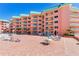Resort featuring a courtyard with lounge chairs and sun umbrellas for relaxation at 18400 Gulf Blvd # 1211, Indian Shores, FL 33785