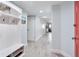 Hallway featuring light blue walls, white trim, and a built-in hall tree at 18400 Gulf Blvd # 1211, Indian Shores, FL 33785