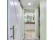 Hallway with a sliding barn door, features access to the walk-in closet and bathroom at 18400 Gulf Blvd # 1211, Indian Shores, FL 33785