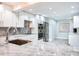 Beautiful kitchen boasting stainless steel appliances, white cabinets, and marble countertops with a view to the second kitchen at 18400 Gulf Blvd # 1211, Indian Shores, FL 33785
