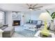 Bright living room featuring a stone fireplace and modern ceiling fan at 18400 Gulf Blvd # 1211, Indian Shores, FL 33785