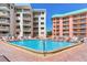 Resort community featuring a refreshing pool area with lounge chairs for relaxation at 18400 Gulf Blvd # 1211, Indian Shores, FL 33785
