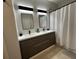 Stylish bathroom vanity with double sinks, modern lighting, and ample storage at 19113 Doves Landing Dr, Tampa, FL 33647