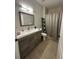 Updated bathroom features a modern vanity, framed mirror, and a shower with curtain at 19113 Doves Landing Dr, Tampa, FL 33647