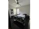 This bedroom has a fan, natural light and includes abstract art for a modern feel at 19113 Doves Landing Dr, Tampa, FL 33647
