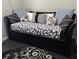 A comfortable daybed with decorative pillows and a leaf-patterned blanket offers a cozy spot for relaxing at 19113 Doves Landing Dr, Tampa, FL 33647