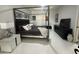 Modern bedroom with a canopy bed, sleek furniture, and minimalist decor at 19113 Doves Landing Dr, Tampa, FL 33647