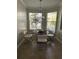Bright breakfast nook with modern light fixture, black table and four modern chairs at 19113 Doves Landing Dr, Tampa, FL 33647