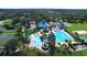 Aerial view of community pool and recreation center with lush landscaping, multiple pools, and tennis courts at 19113 Doves Landing Dr, Tampa, FL 33647