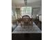 An inviting dining room showcasing a light wood table, seating for six, and decorative rug at 19113 Doves Landing Dr, Tampa, FL 33647