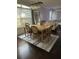 Open dining area featuring a light wood table, comfortable seating, and stylish area rug at 19113 Doves Landing Dr, Tampa, FL 33647